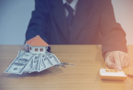 someone holding cash and calculating