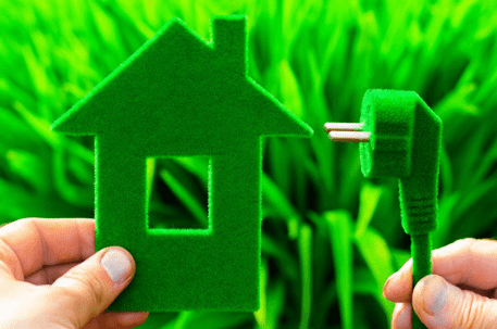 Home plugged into green grass graphic